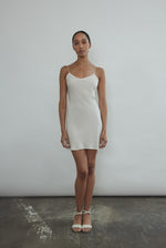Angled view of the ivory silk Kamperett V-Neck Mini Slip.