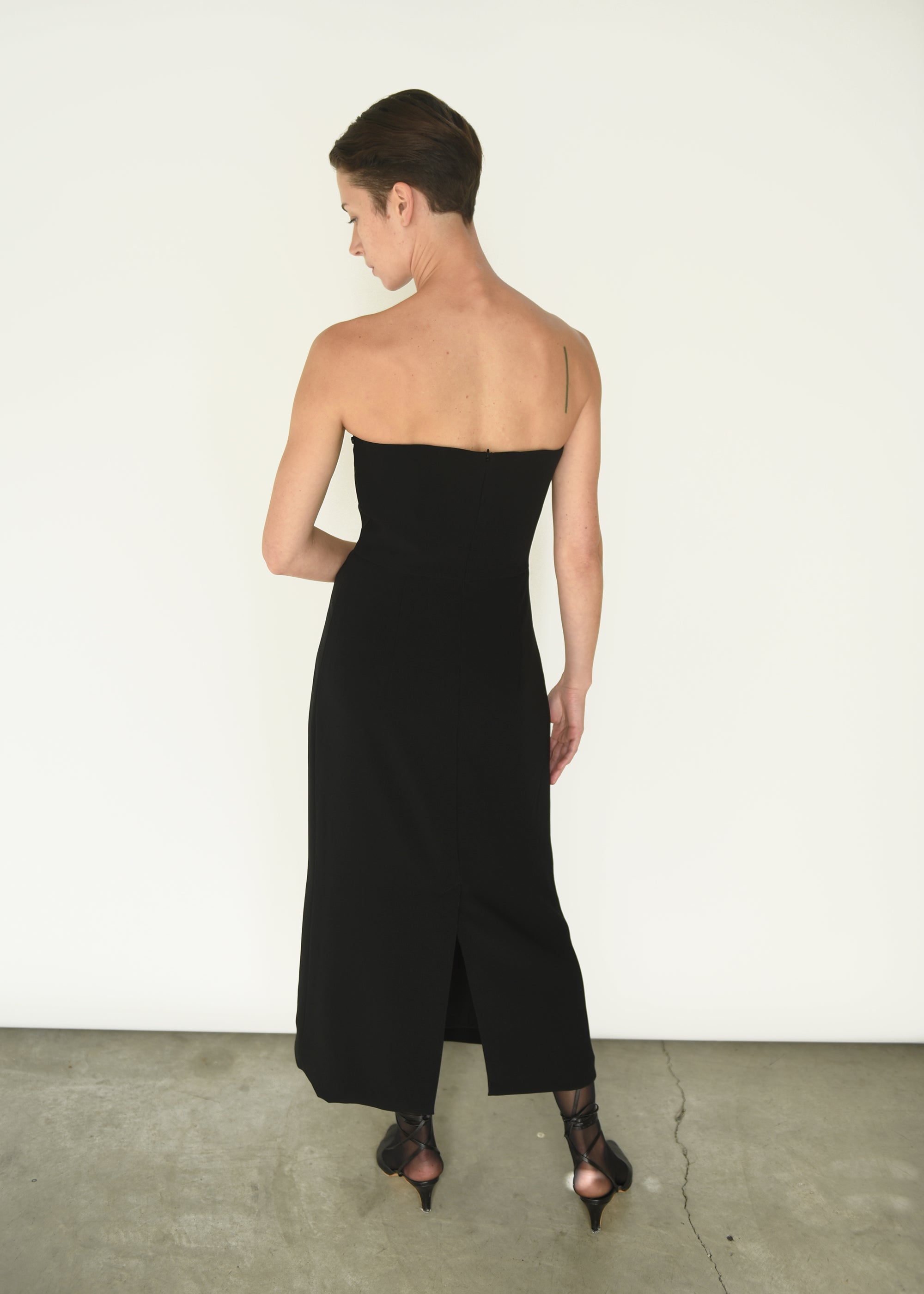 Back view of the black crepe Kamperett Verona Midi Dress with zipper closure at center back.