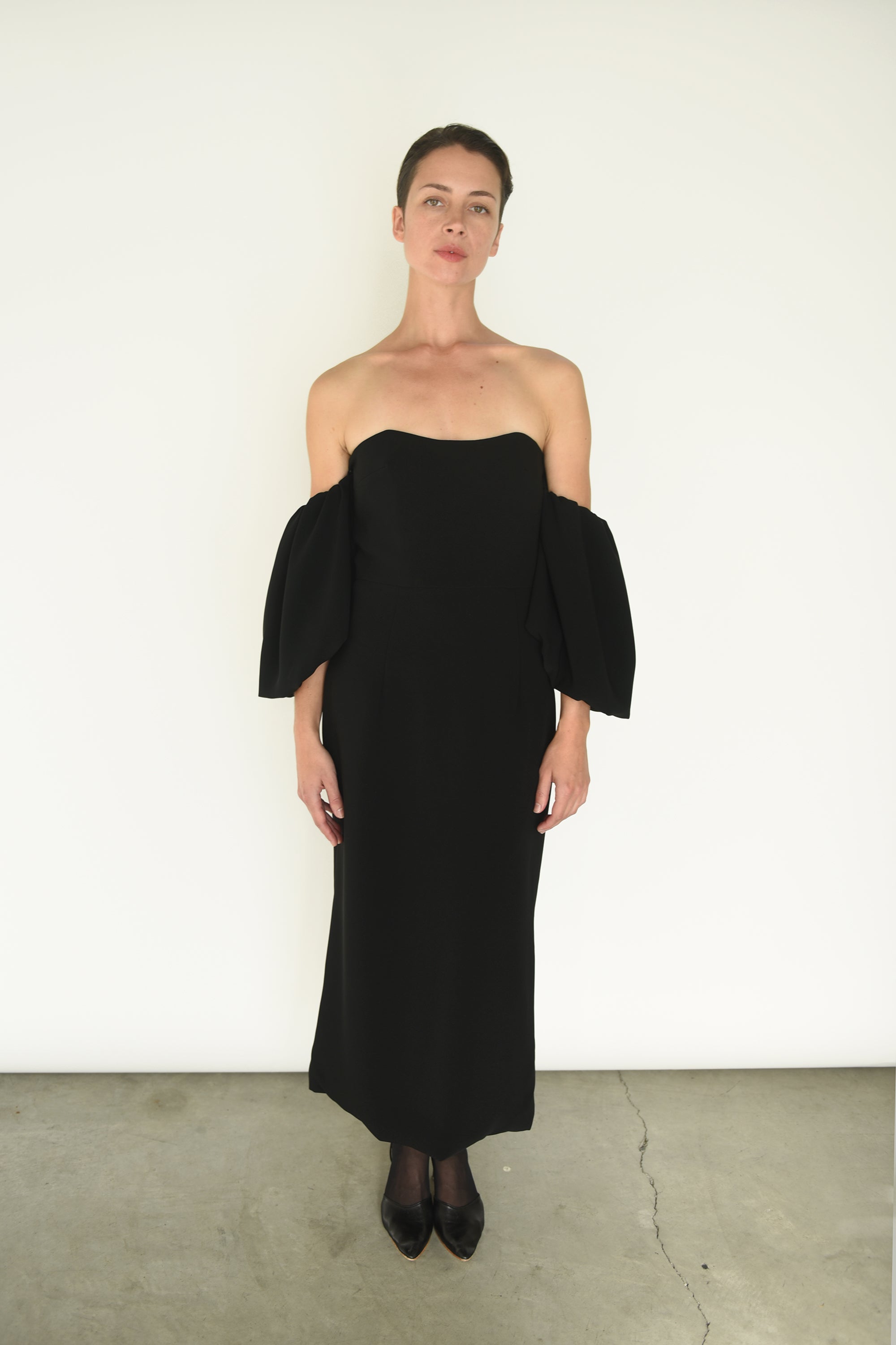 Close-up of the boned bodice and waist seaming on the black crepe Kamperett Verona Midi Dress.