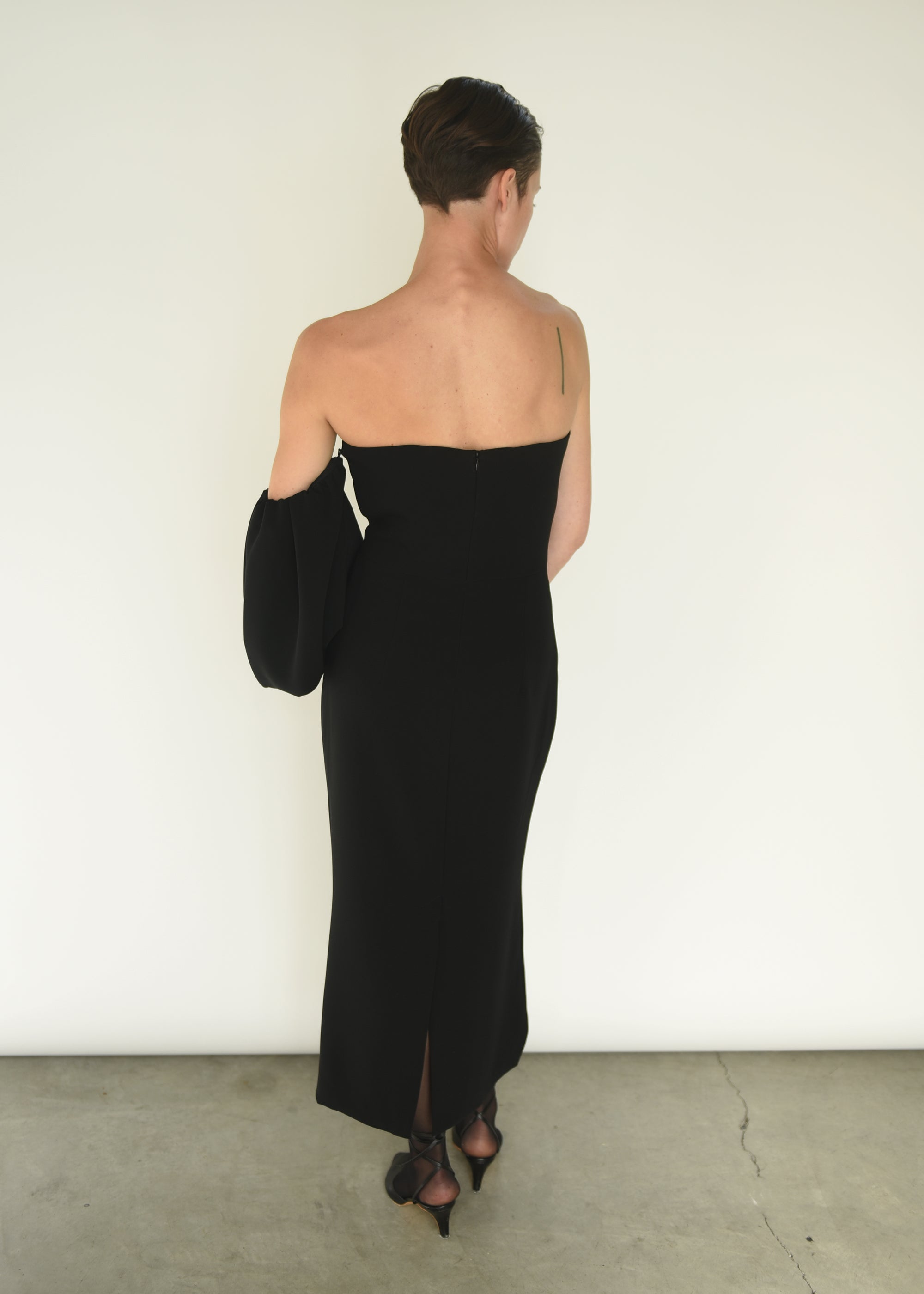 Detail of the detachable draped sleeves on the black crepe Kamperett Verona Midi Dress.