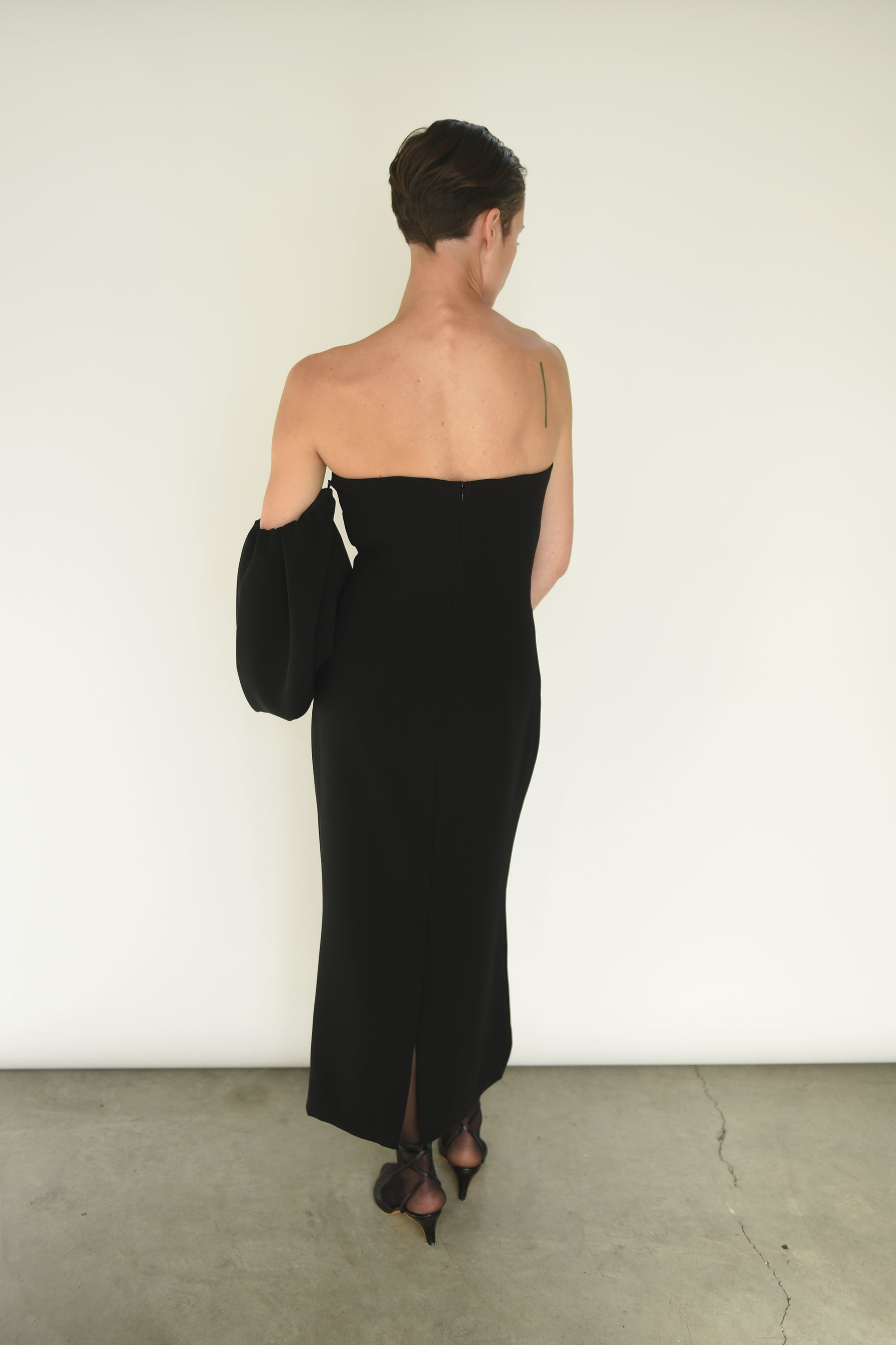Detail of the detachable draped sleeves on the black crepe Kamperett Verona Midi Dress.