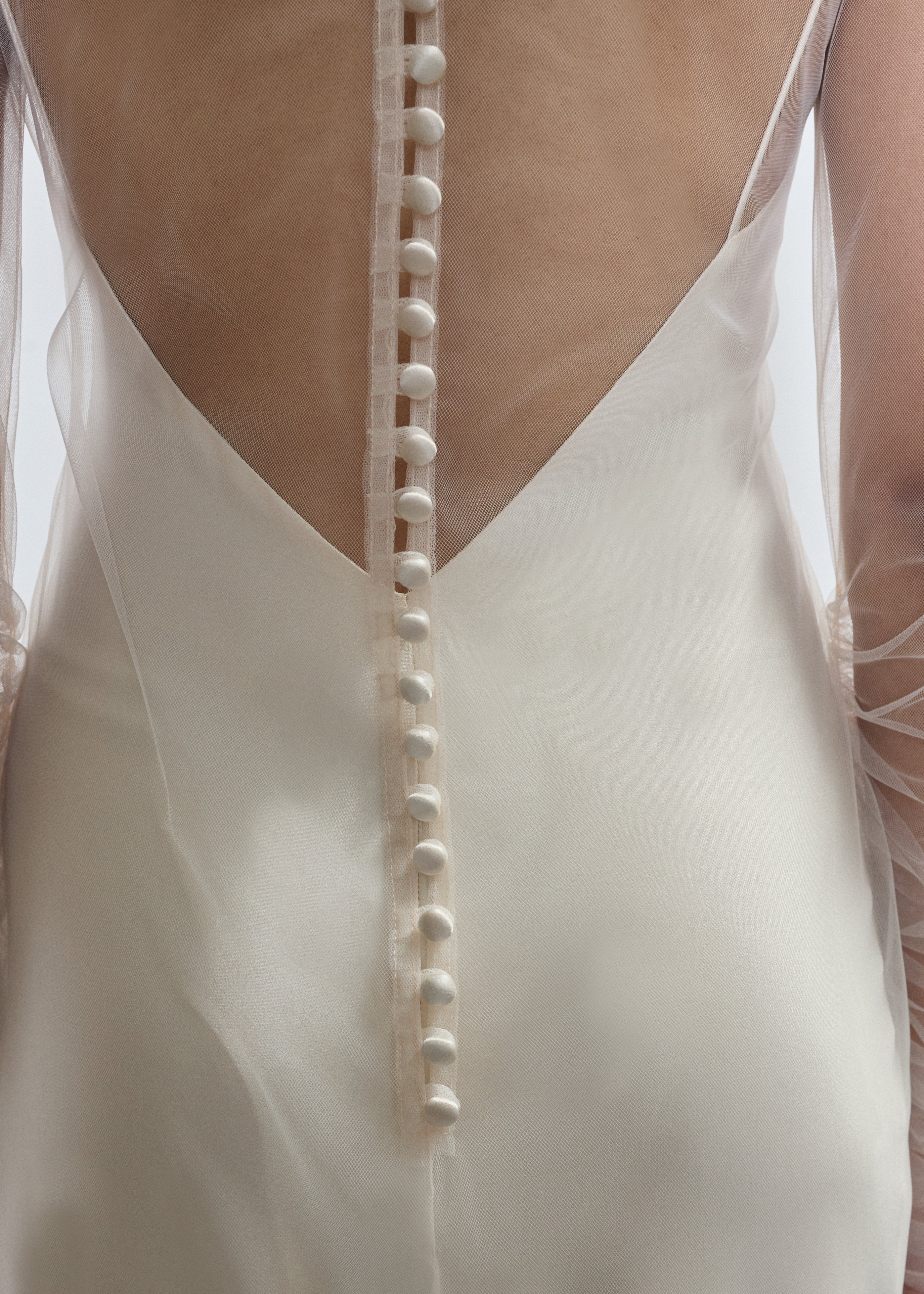 Rear view of ivory Violette Tulle Sheath showing extended button closure at center back. Architectural construction, handcrafted in California from 100% tulle.