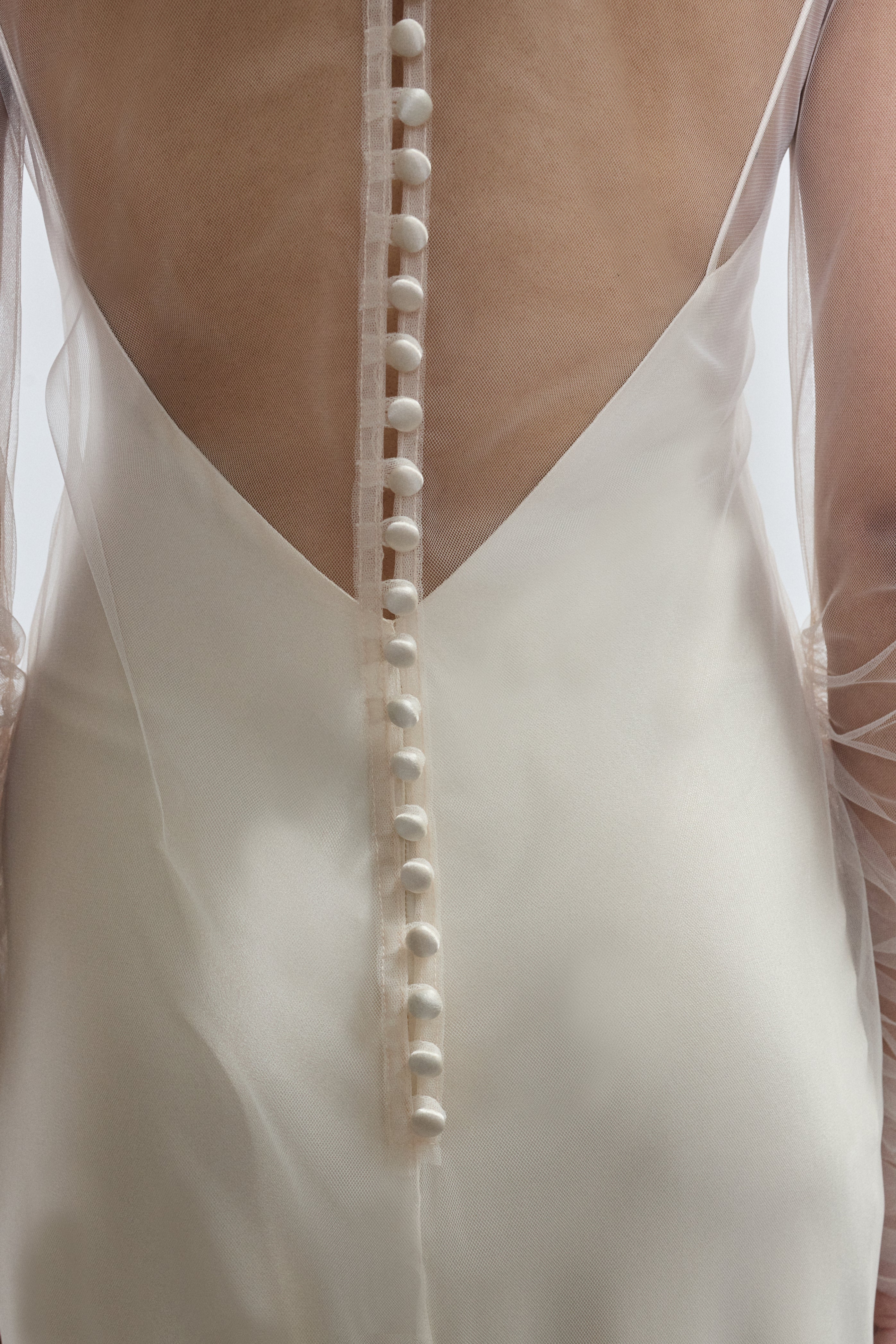 Rear view of ivory Violette Tulle Sheath showing extended button closure at center back. Architectural construction, handcrafted in California from 100% tulle.
