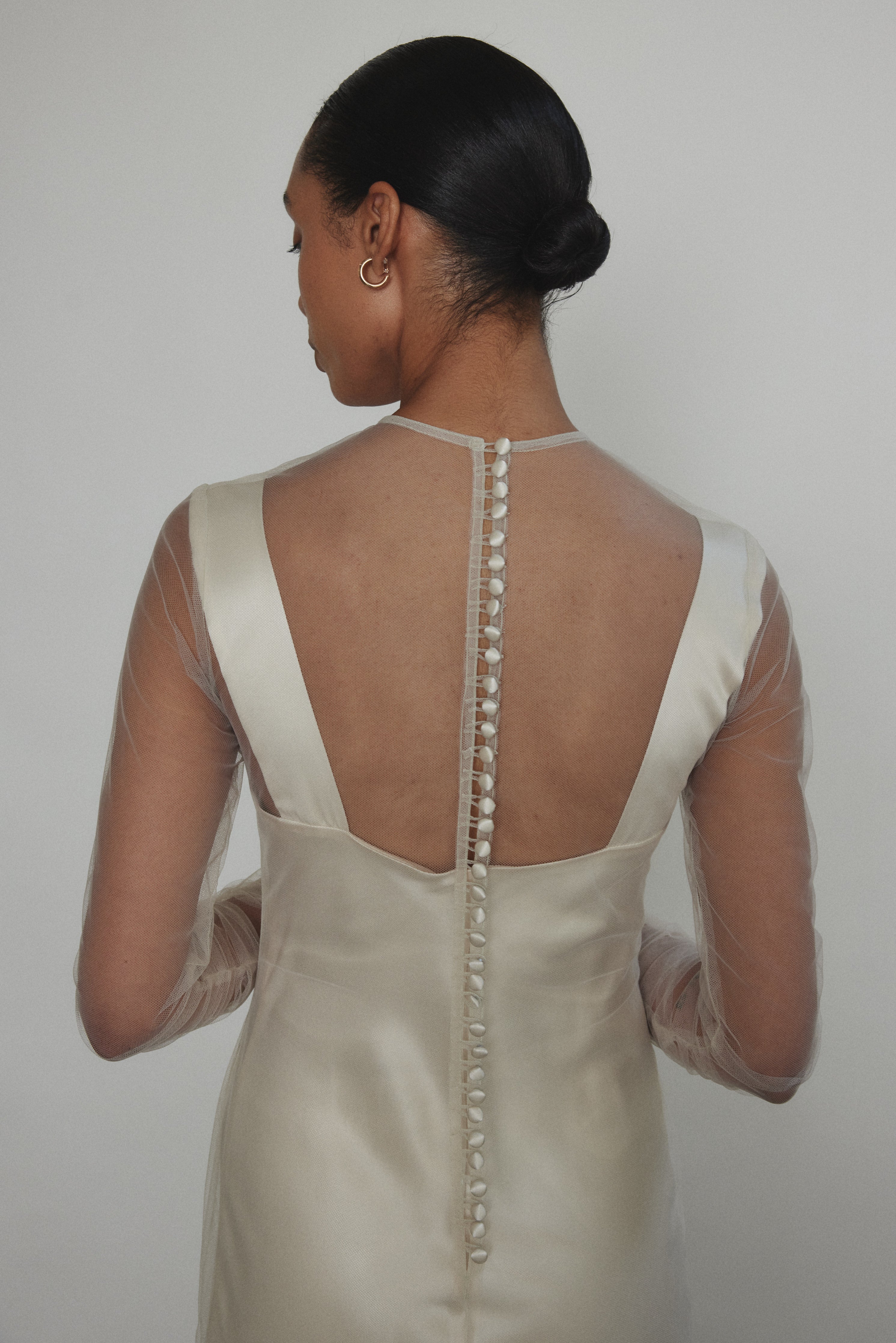 Rear view of ivory Violette Tulle Sheath showing extended button closure at center back. Architectural construction, handcrafted in California from 100% tulle.