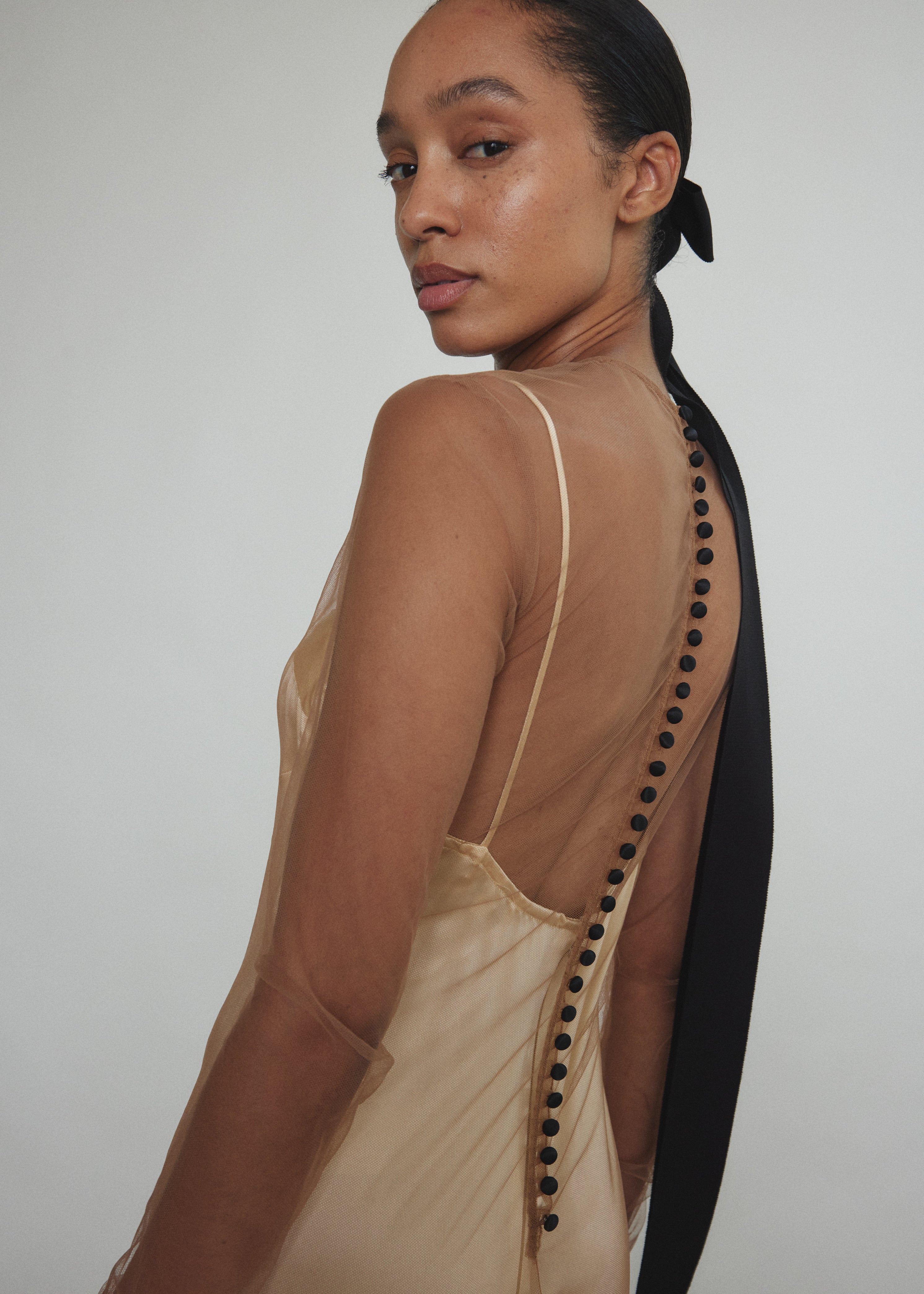 Close-up of Kamperett Violette Tulle Sheath in mocha — extended button closure at center back, California-made.