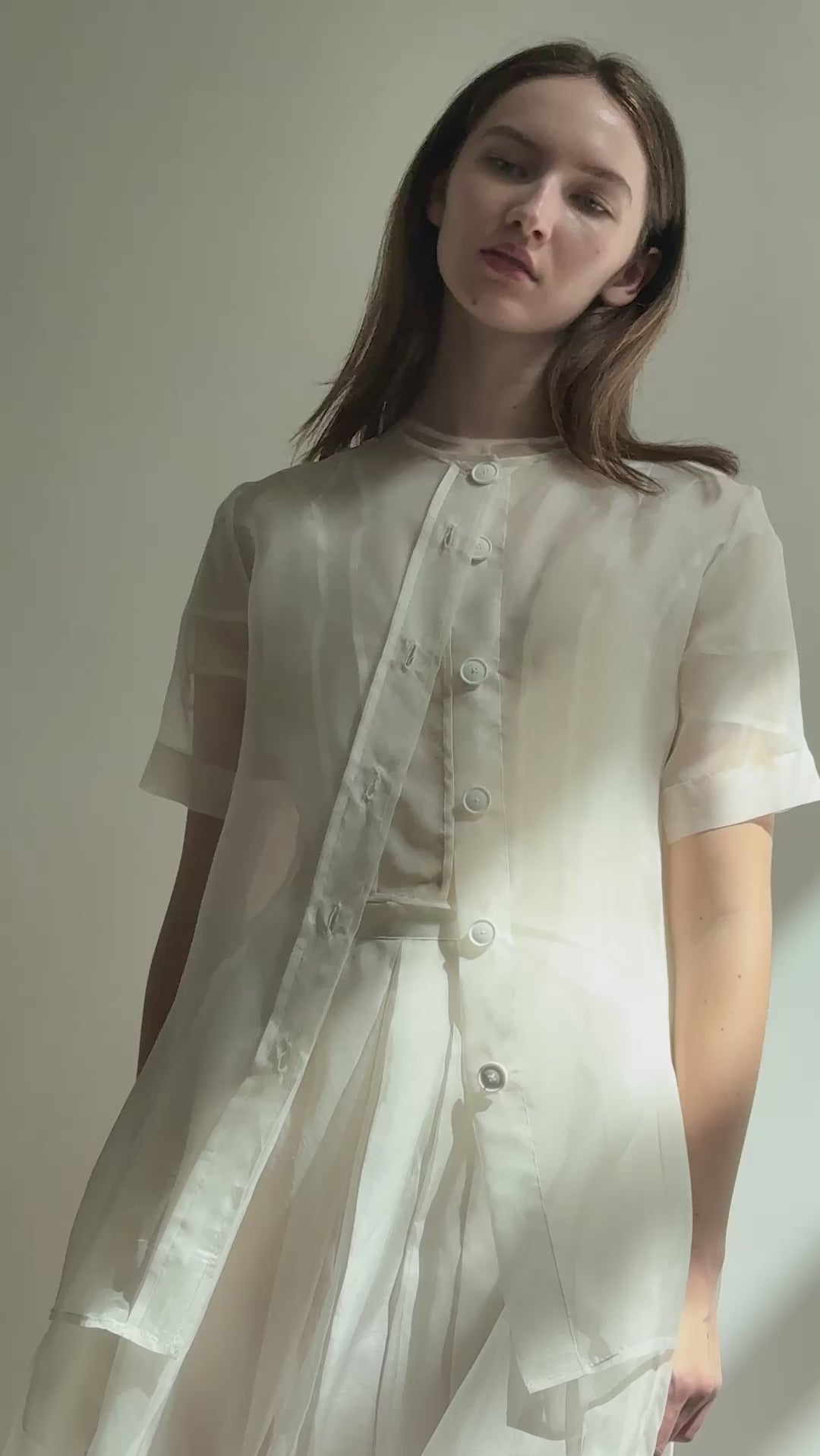 Model wearing the Alabaster silk organza Brise Skirt, showcasing its voluminous silhouette, sheer fabric, and elegant midi-length drape.