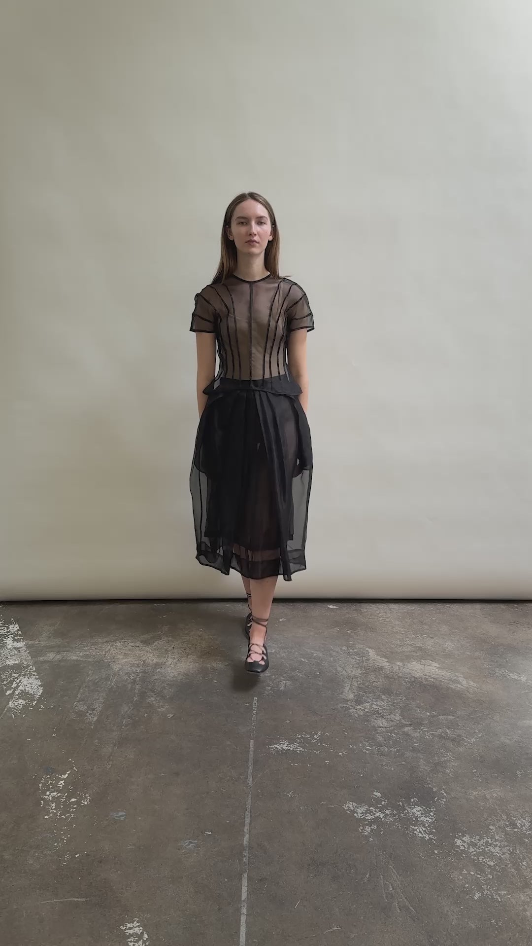 Model wearing the Black silk organza Brise Skirt, showcasing its voluminous silhouette, sheer fabric, and elegant midi-length drape.