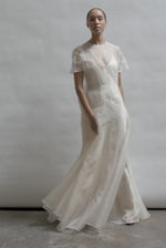 Model wearing the voluminous Kamperett Anemoia Gown in Ivory silk organza, featuring architectural French seams and a graceful floor-length silhouette.