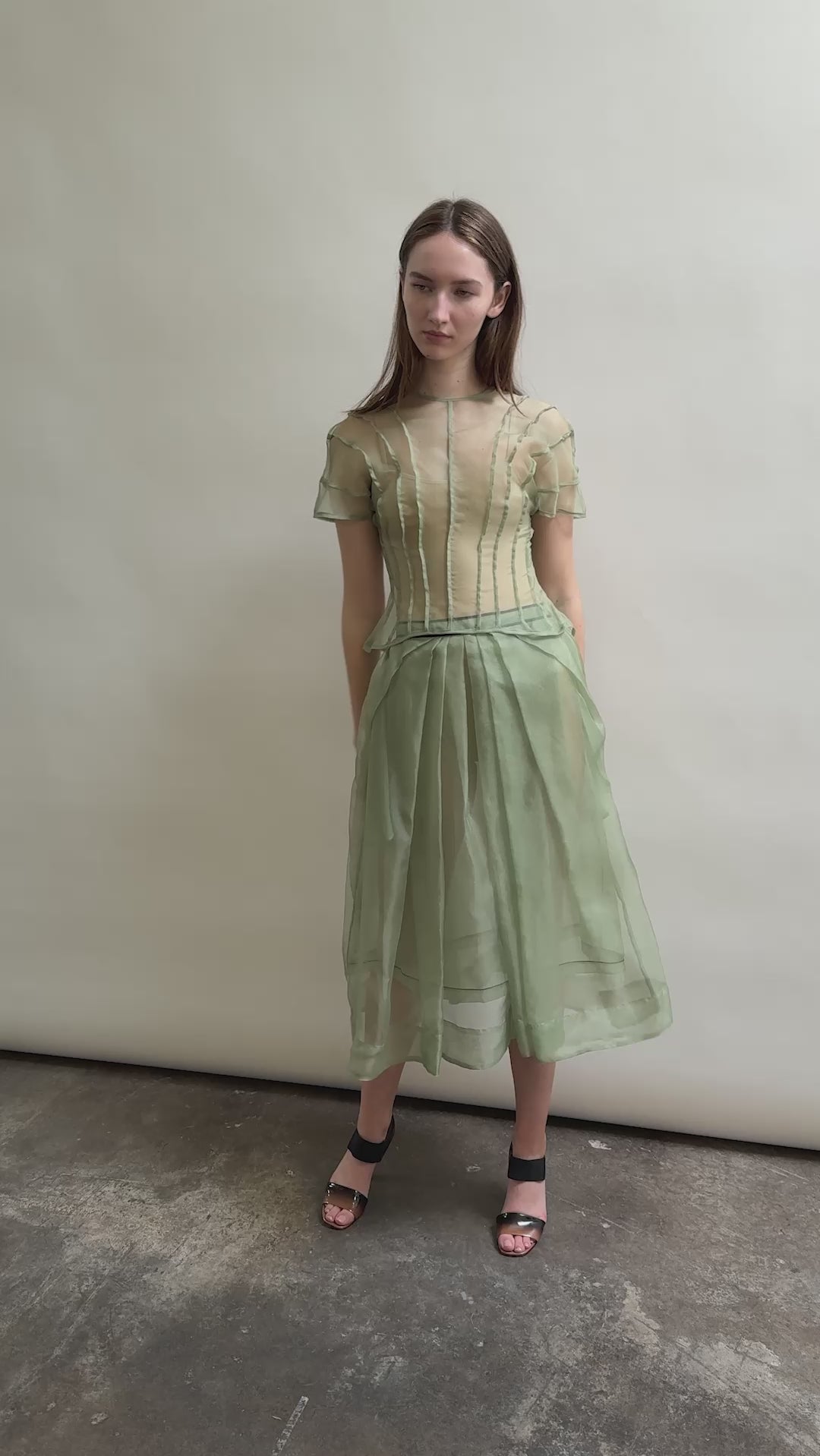 Model wearing the Jade silk organza Brise Skirt, showcasing its voluminous silhouette, sheer fabric, and elegant midi-length drape.