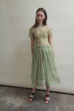 Model wearing the Jade silk organza Brise Skirt, showcasing its voluminous silhouette, sheer fabric, and elegant midi-length drape.