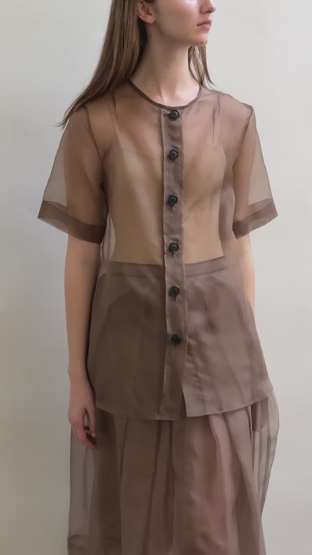 Model wearing the Mushroom silk organza Brise Skirt, showcasing its voluminous silhouette, sheer fabric, and elegant midi-length drape.