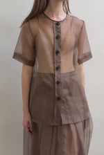 Model wearing the Mushroom silk organza Brise Skirt, showcasing its voluminous silhouette, sheer fabric, and elegant midi-length drape.