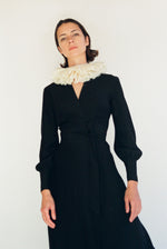 Detail of the wrap neckline on the black matte silk charmeuse Kamperett Adelaide Midi Dress.