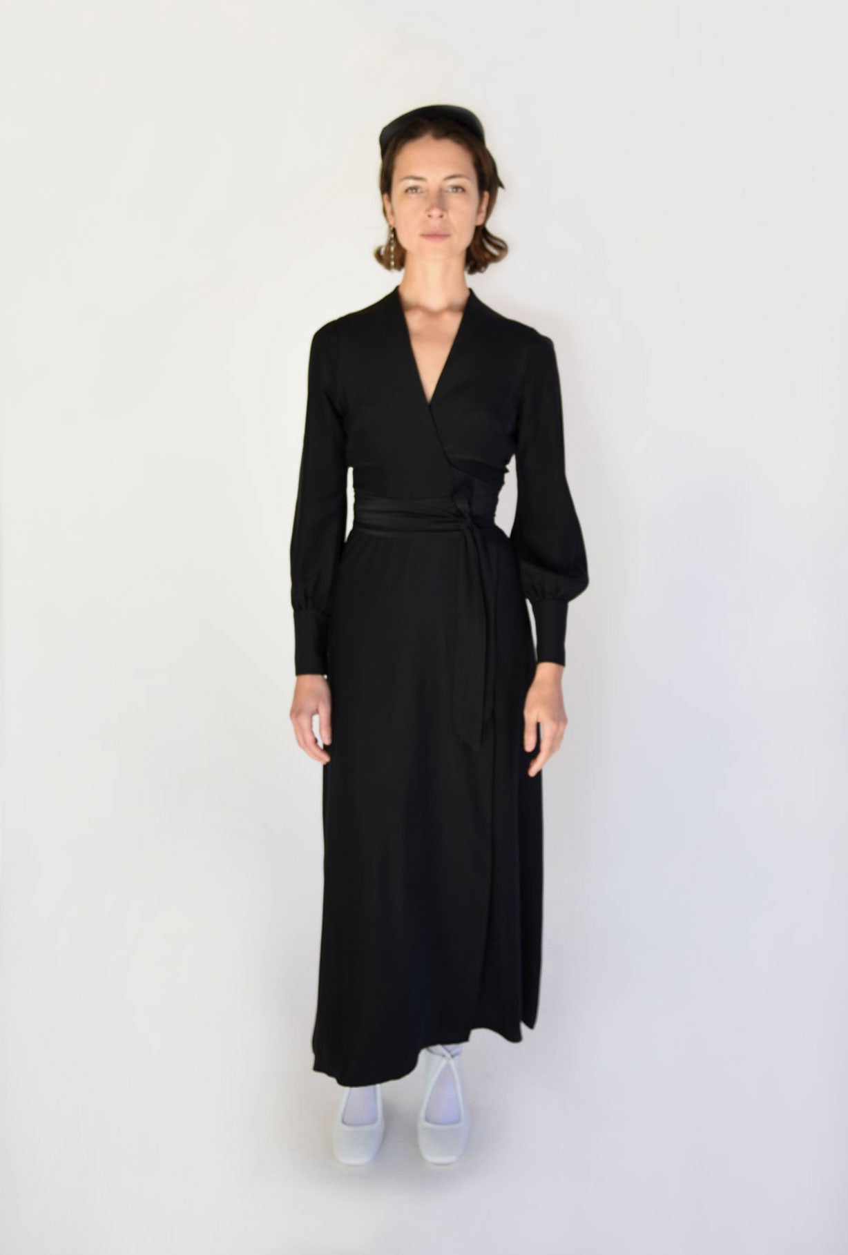 Side view of the black matte silk charmeuse Kamperett Adelaide Midi Dress.