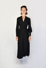 Side view of the black matte silk charmeuse Kamperett Adelaide Midi Dress.