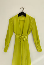 Detail of the chartreuse satin silk charmeuse Kamperett Adelaide Midi Dress fabric and wrap construction.