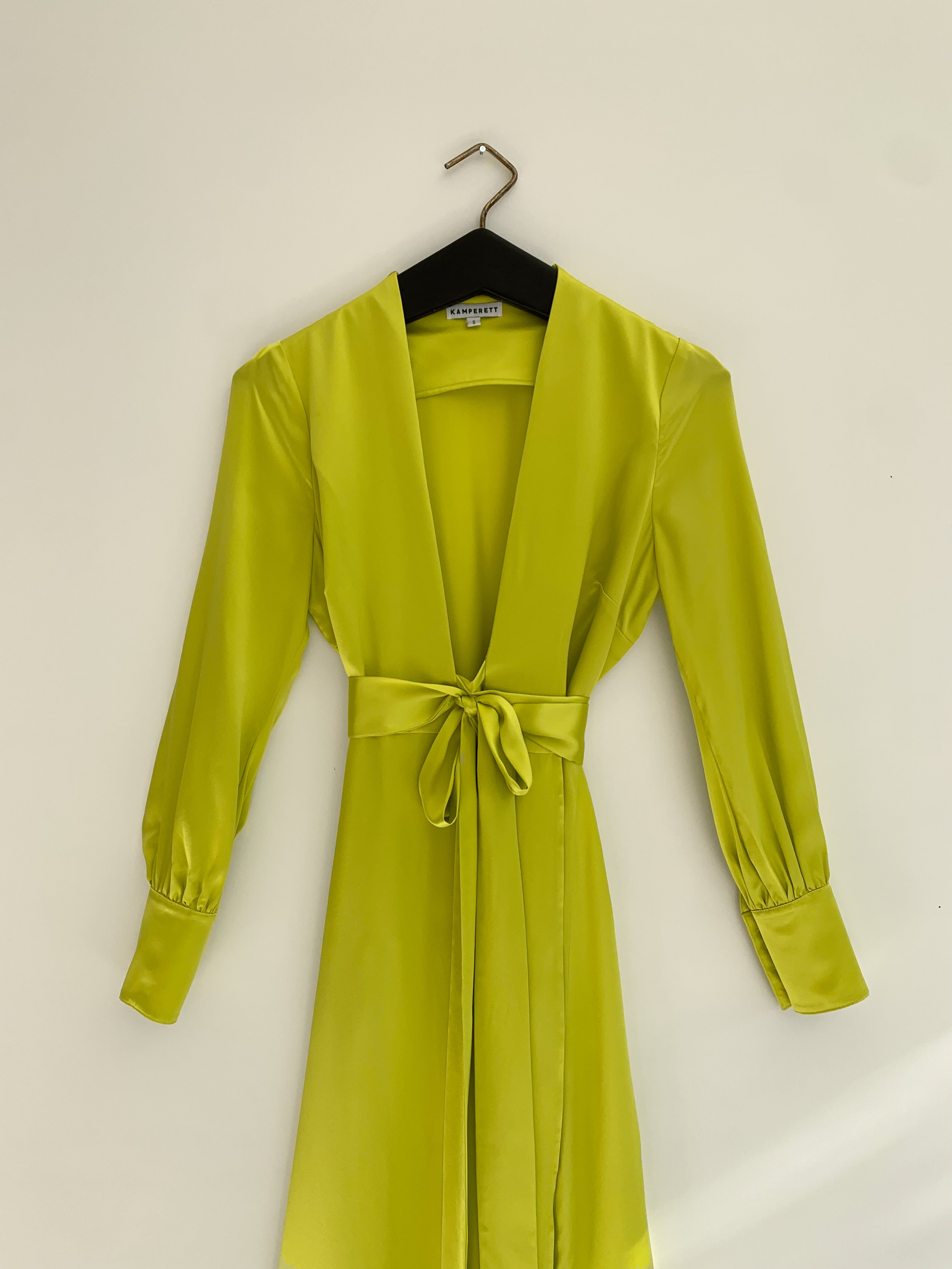Detail of the chartreuse satin silk charmeuse Kamperett Adelaide Midi Dress fabric and wrap construction.