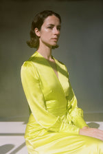 Editorial image of the chartreuse satin silk charmeuse Kamperett Adelaide Midi Dress.