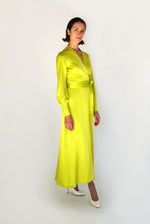 Front view of a model wearing the chartreuse satin silk charmeuse Kamperett Adelaide Midi Dress, a wrap dress with plunging neckline and full sleeves.