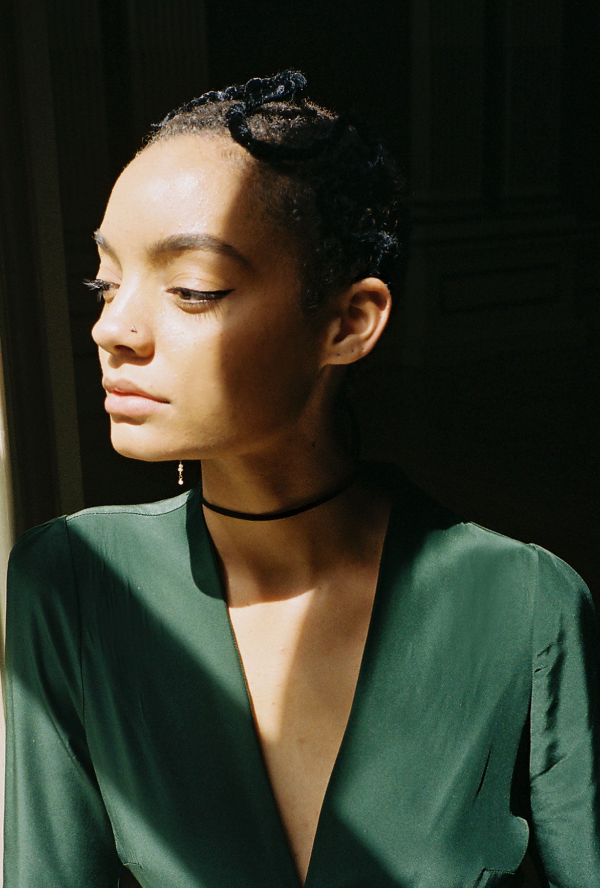 Motion shot of the dark green matte silk charmeuse Kamperett Adelaide Midi Dress, capturing the fluid drape.