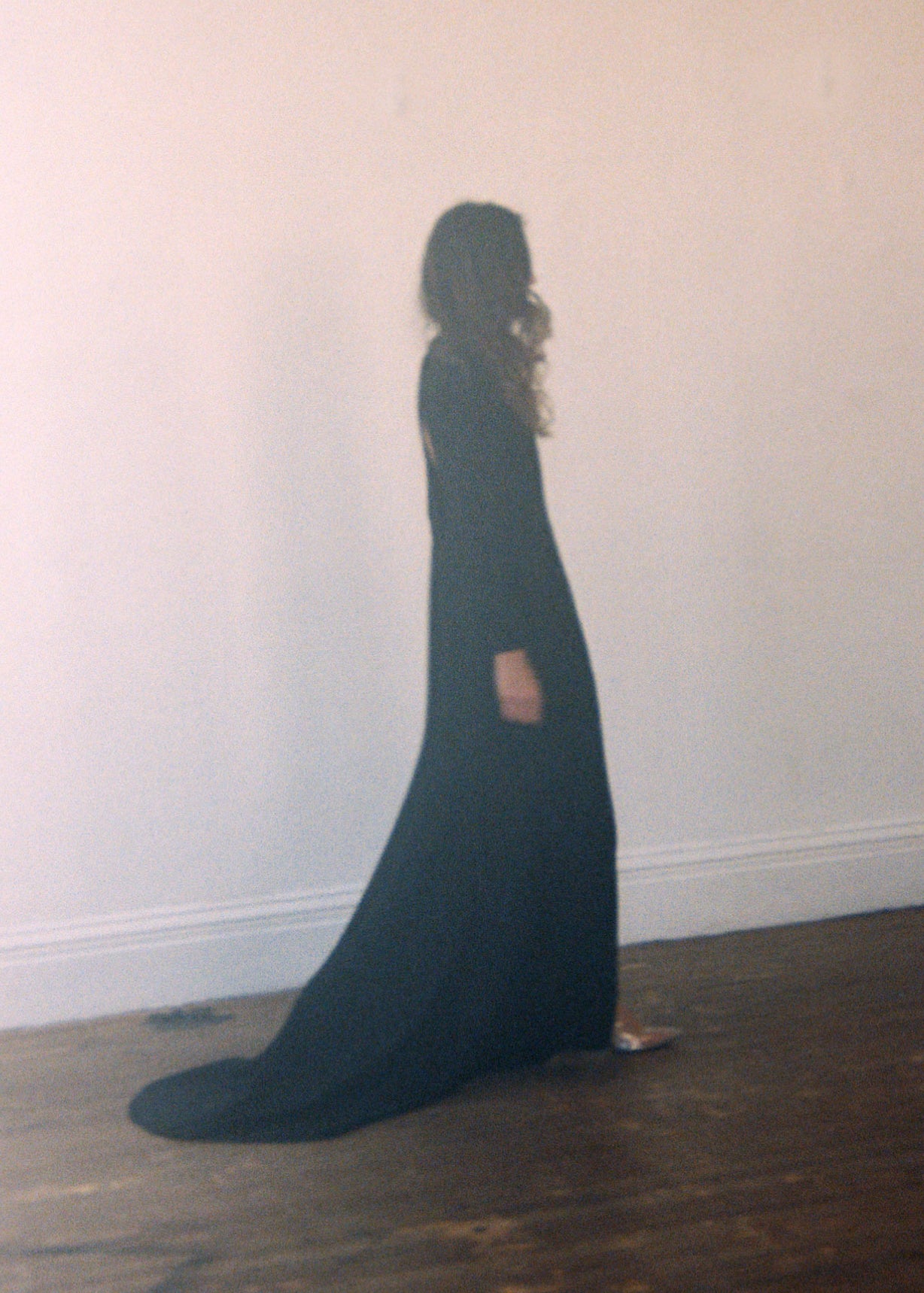 Side view of the black acetate crepe Kamperett Arc Gown showing the dramatic side slit.