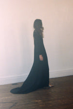 Side view of the black acetate crepe Kamperett Arc Gown showing the dramatic side slit.