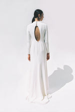 Full-length view of the Kamperett Arc Gown in Ivory silk crepe, featuring a minimalist mock neck, long tapered sleeves, and a sculptural side leg slit.
