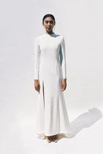 Full-length view of the Kamperett Arc Gown in Ivory silk crepe, featuring a minimalist mock neck, long tapered sleeves, and a sculptural side leg slit.