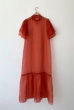 Back view of the rust silk organza Kamperett Barre Dress with grosgrain button closure at center back.