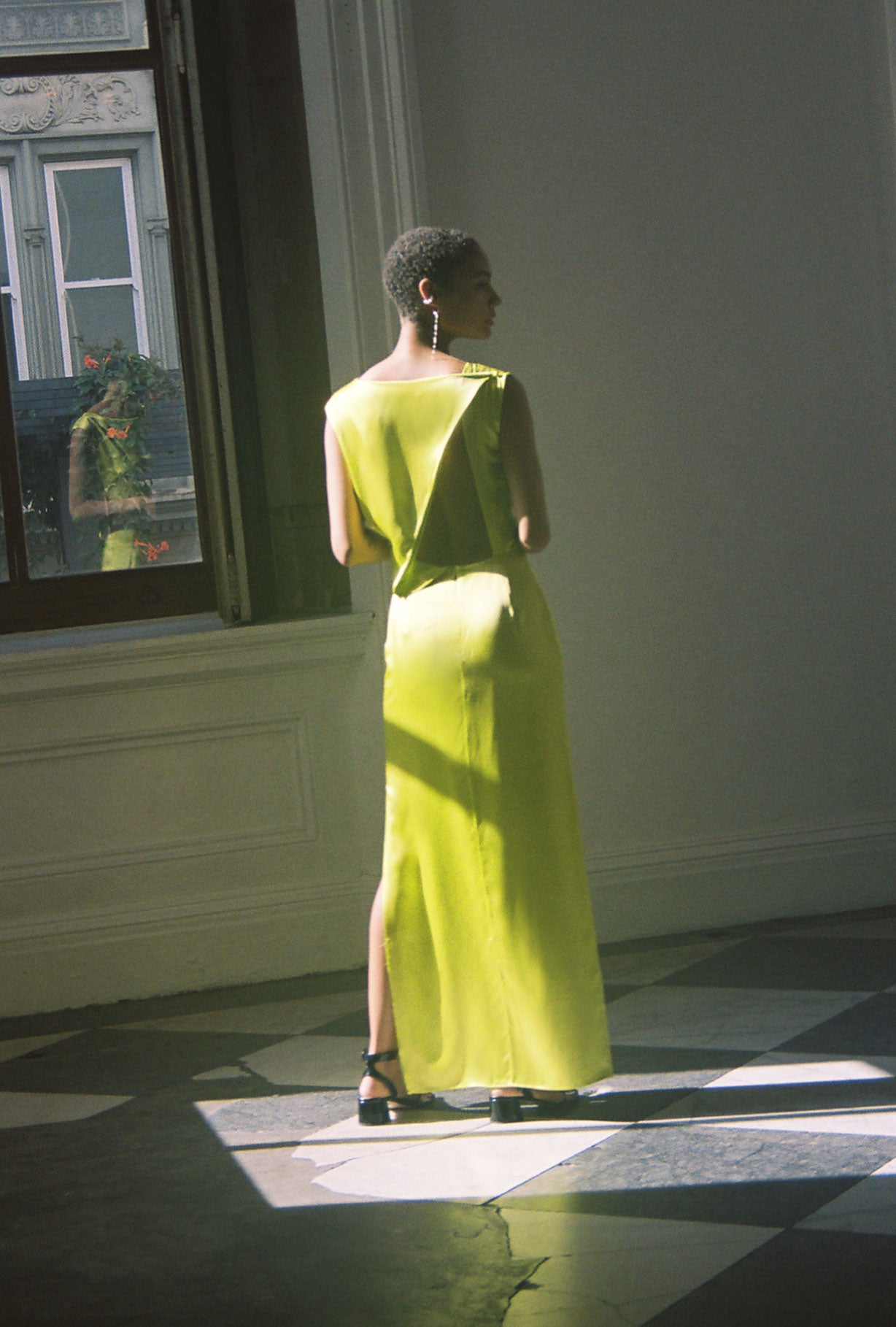 Back view of the chartreuse silk charmeuse Kamperett Lockwood Gown with dramatic asymmetrical back cut-out.