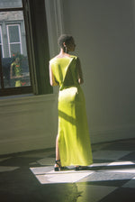 Back view of the chartreuse silk charmeuse Kamperett Lockwood Gown with dramatic asymmetrical back cut-out.