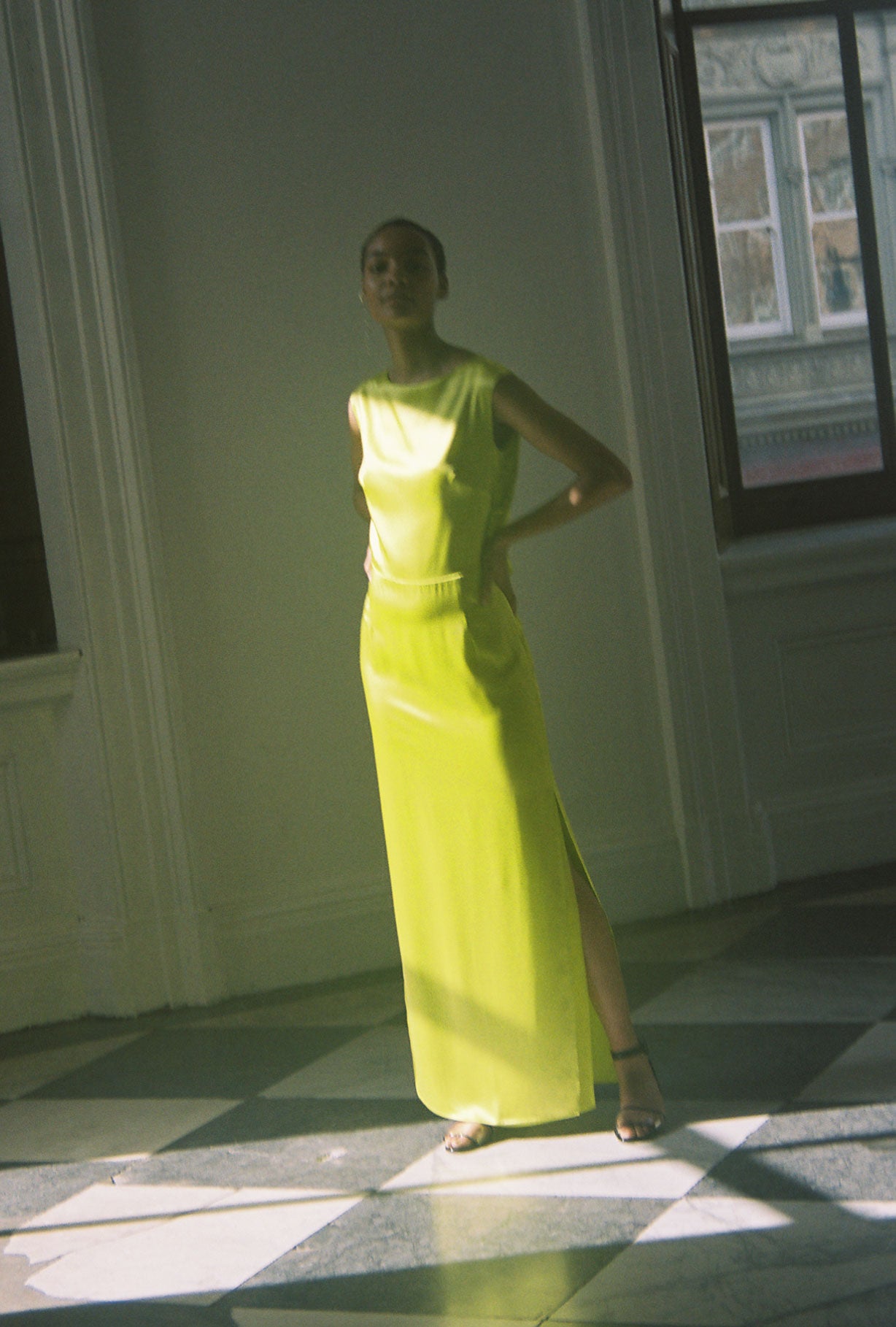 Editorial image of the chartreuse silk charmeuse Kamperett Lockwood Gown.