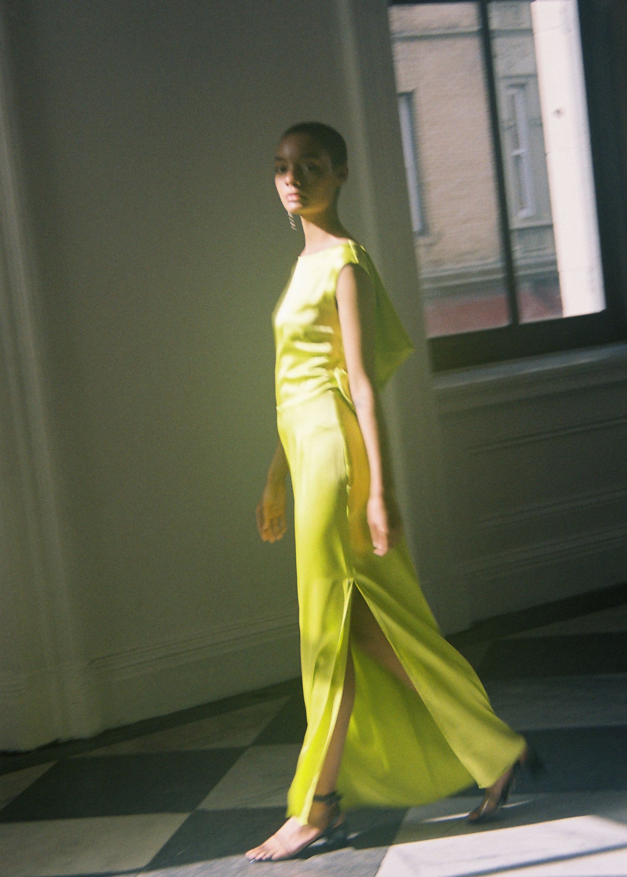 Front view of a model wearing the chartreuse silk charmeuse Kamperett Lockwood Gown, a sleeveless floor-length column.