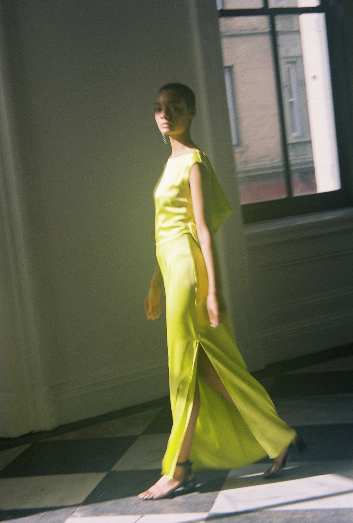 Front view of a model wearing the chartreuse silk charmeuse Kamperett Lockwood Gown, a sleeveless floor-length column.
