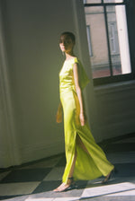 Front view of a model wearing the chartreuse silk charmeuse Kamperett Lockwood Gown, a sleeveless floor-length column.