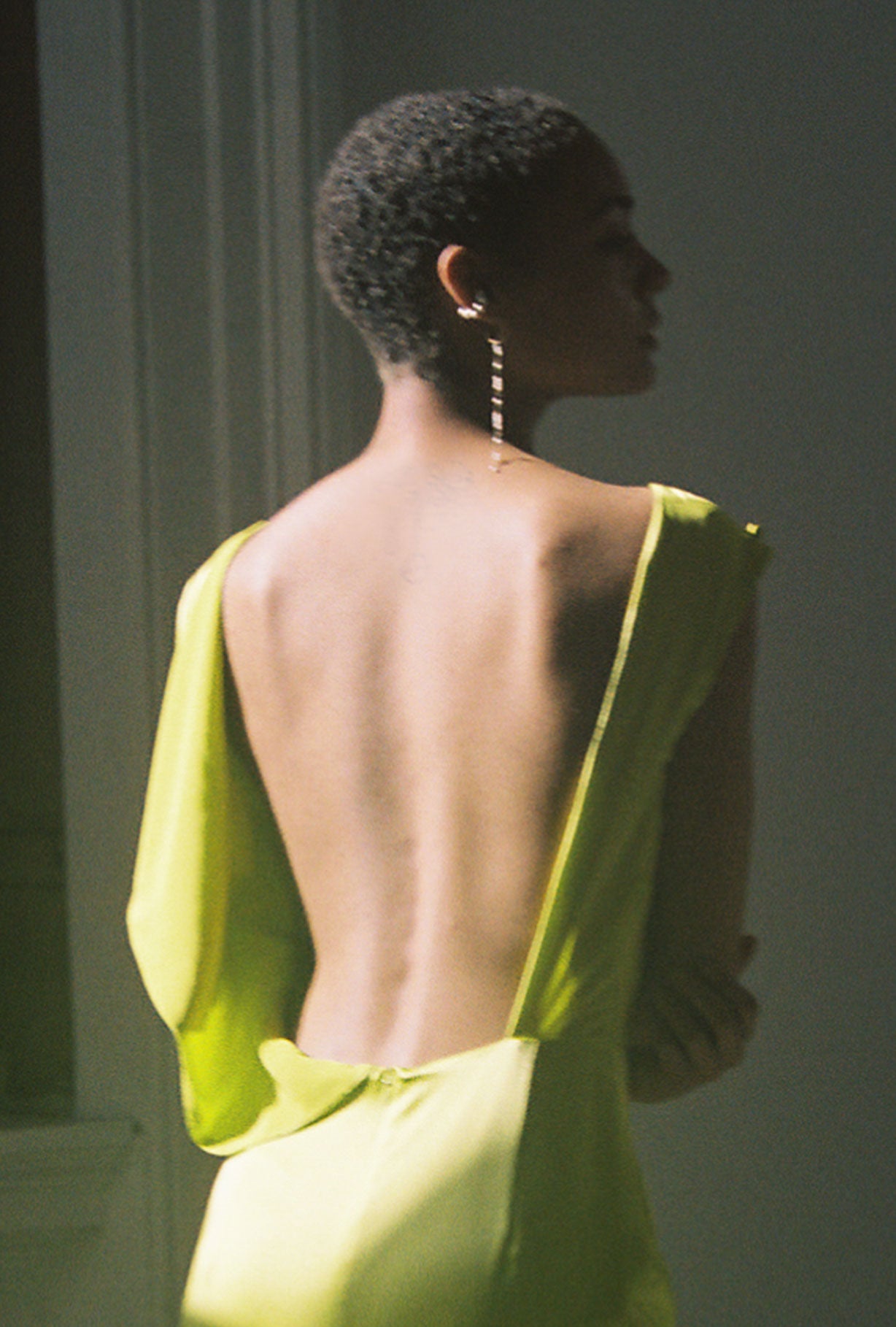 Detail of the column silhouette and side slit on the chartreuse silk charmeuse Kamperett Lockwood Gown.