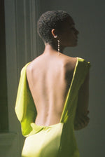 Detail of the column silhouette and side slit on the chartreuse silk charmeuse Kamperett Lockwood Gown.