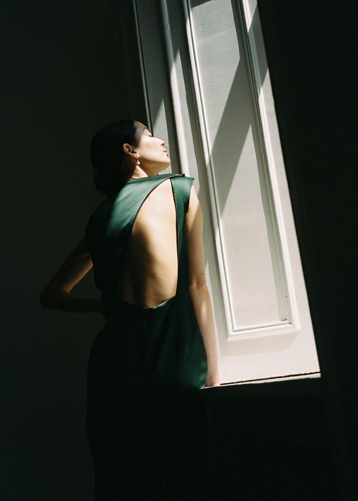 Editorial image of the dark green silk charmeuse Kamperett Lockwood Gown.