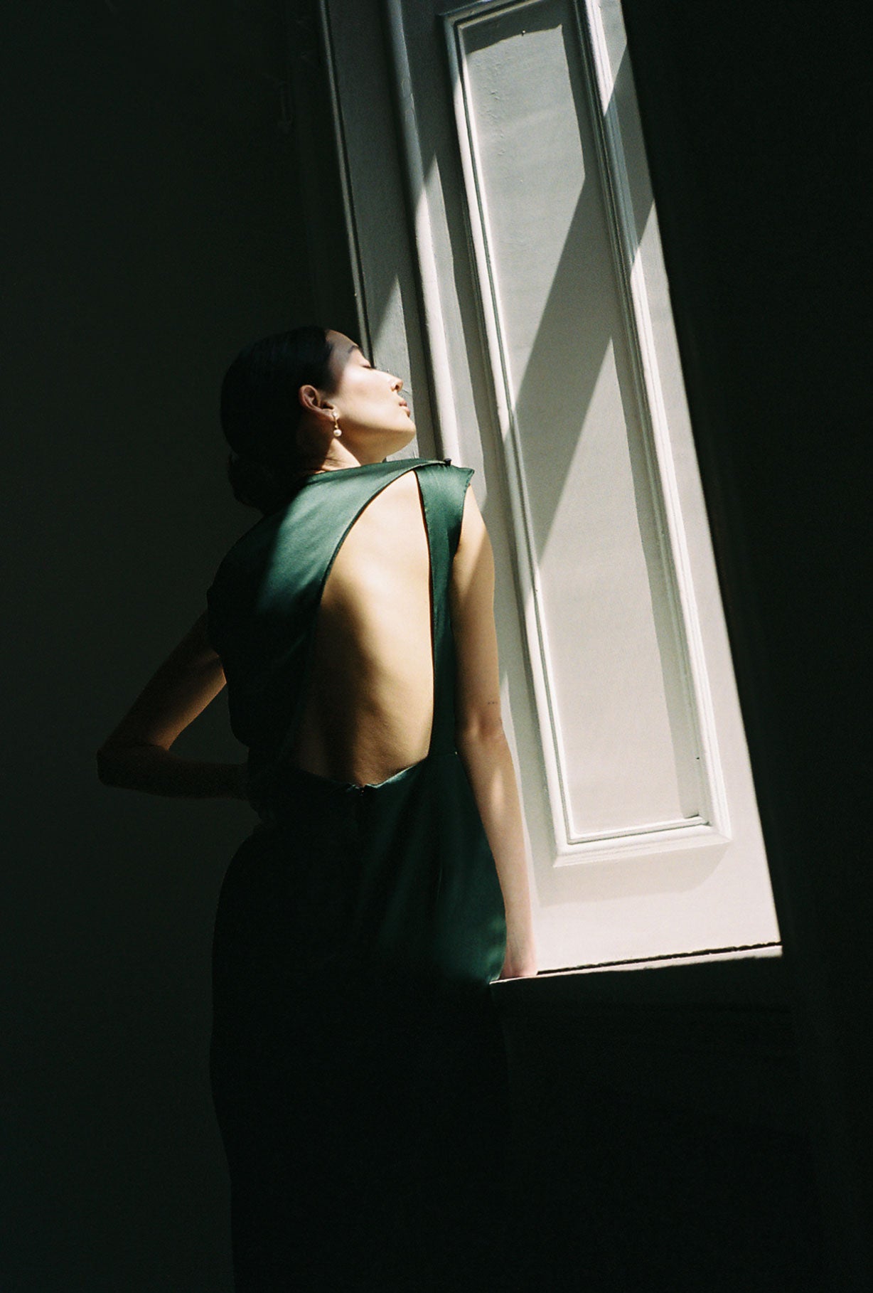 Editorial image of the dark green silk charmeuse Kamperett Lockwood Gown.