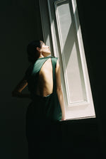 Editorial image of the dark green silk charmeuse Kamperett Lockwood Gown.