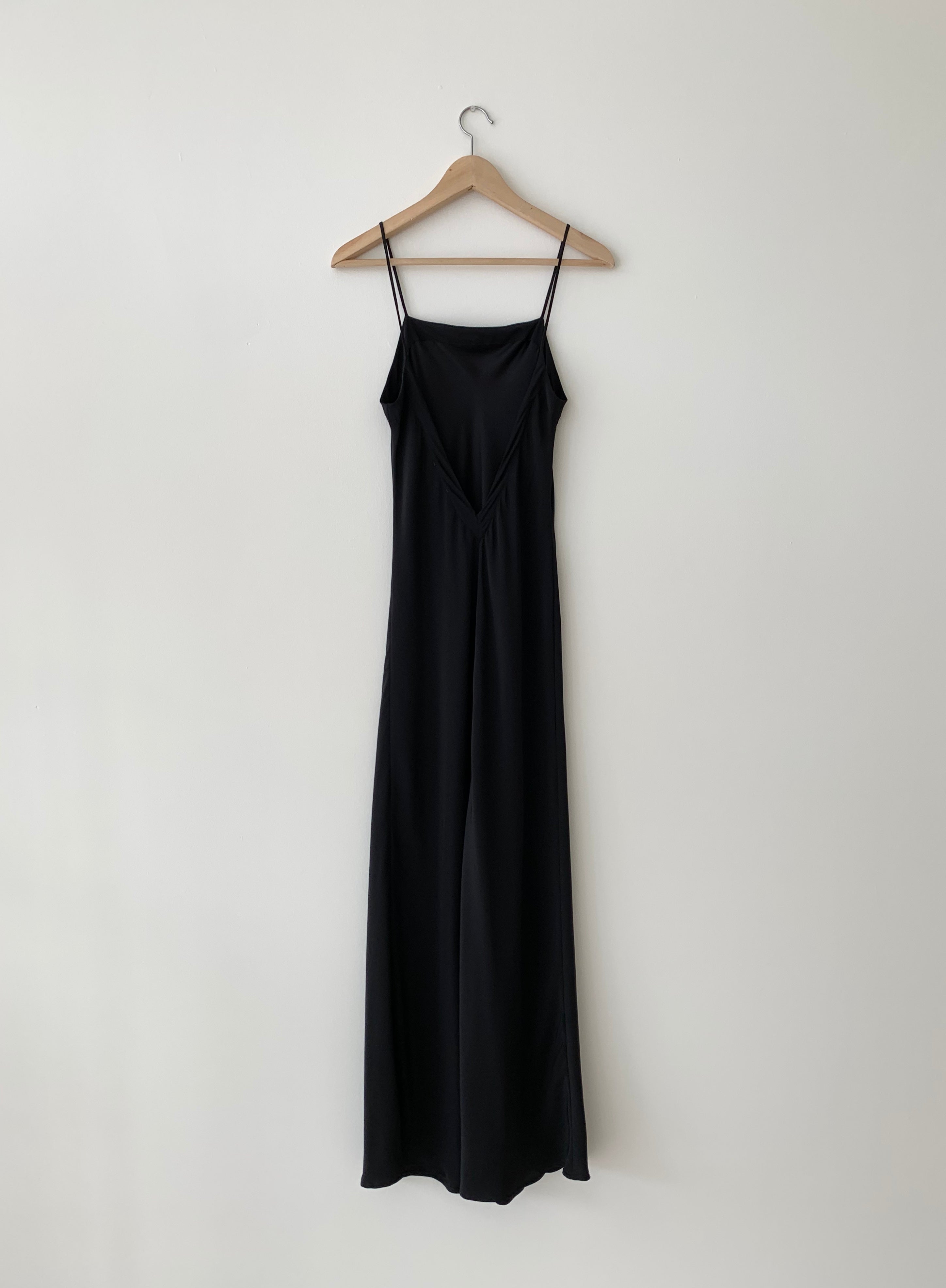 Back view of the black matte silk charmeuse Kamperett Long Slip showing the deep V back.