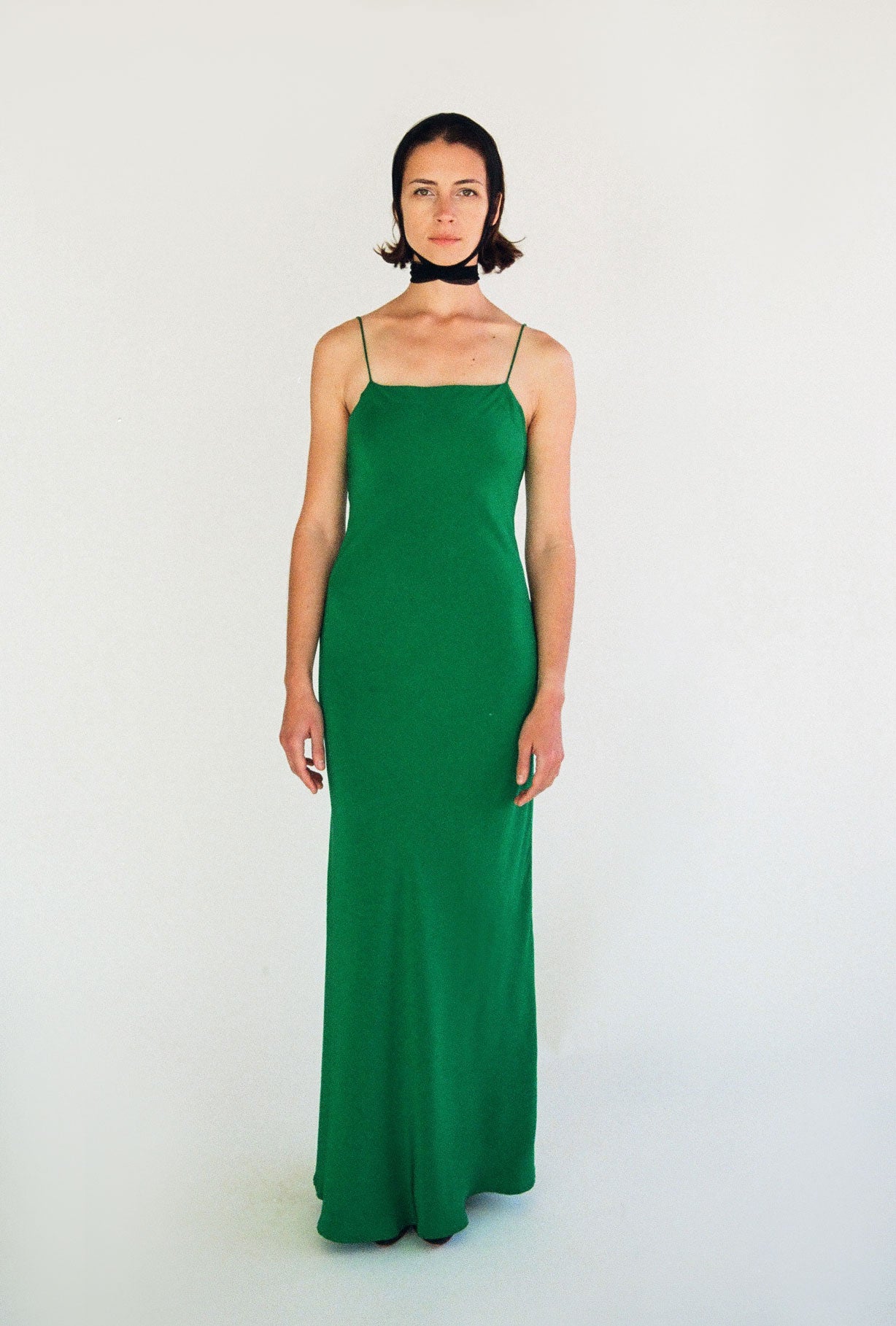 Side view of the kelly green matte silk charmeuse Kamperett Long Slip showing the bias-cut drape.