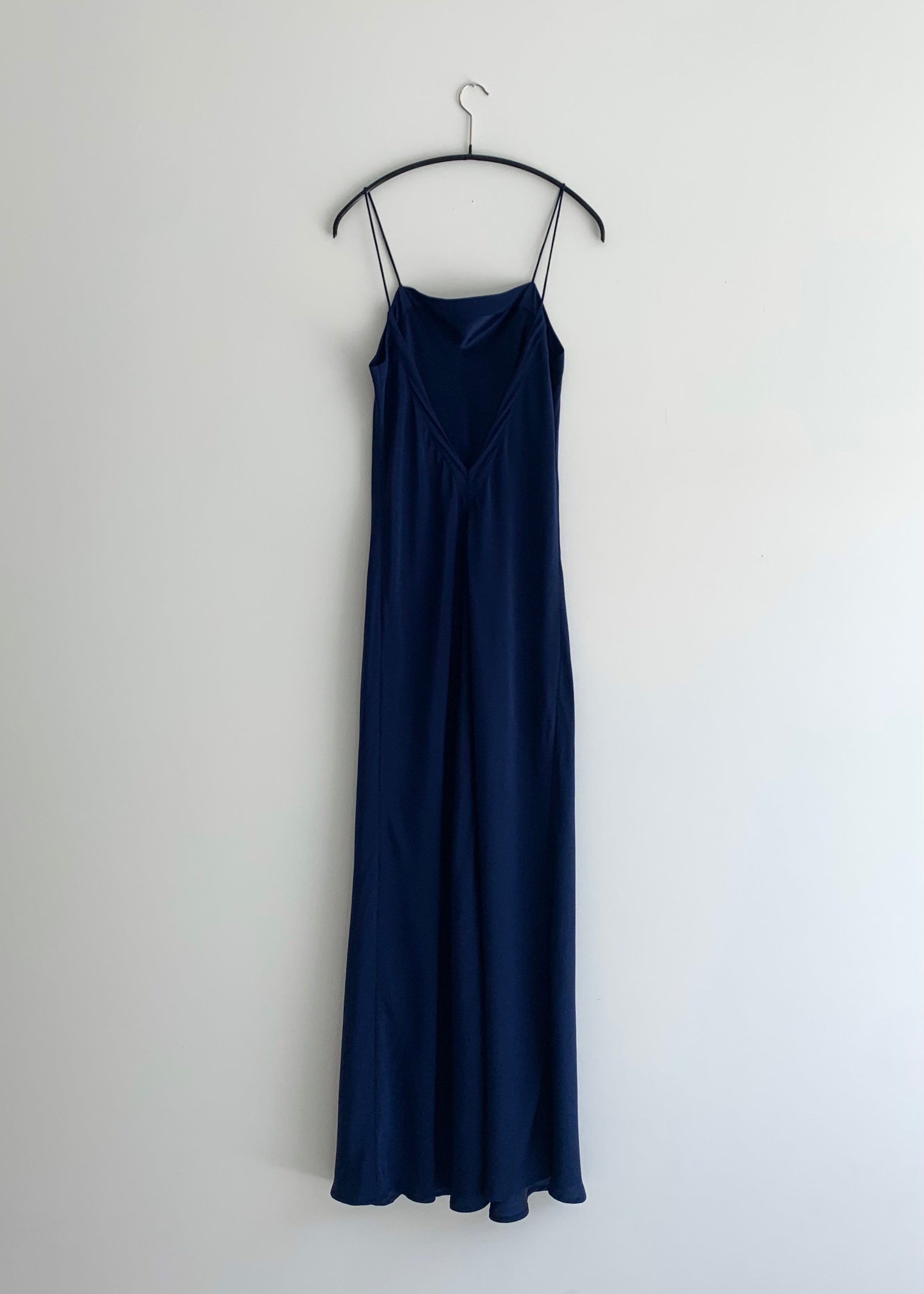 Back view of the navy matte silk charmeuse Kamperett Long Slip showing the deep V back.