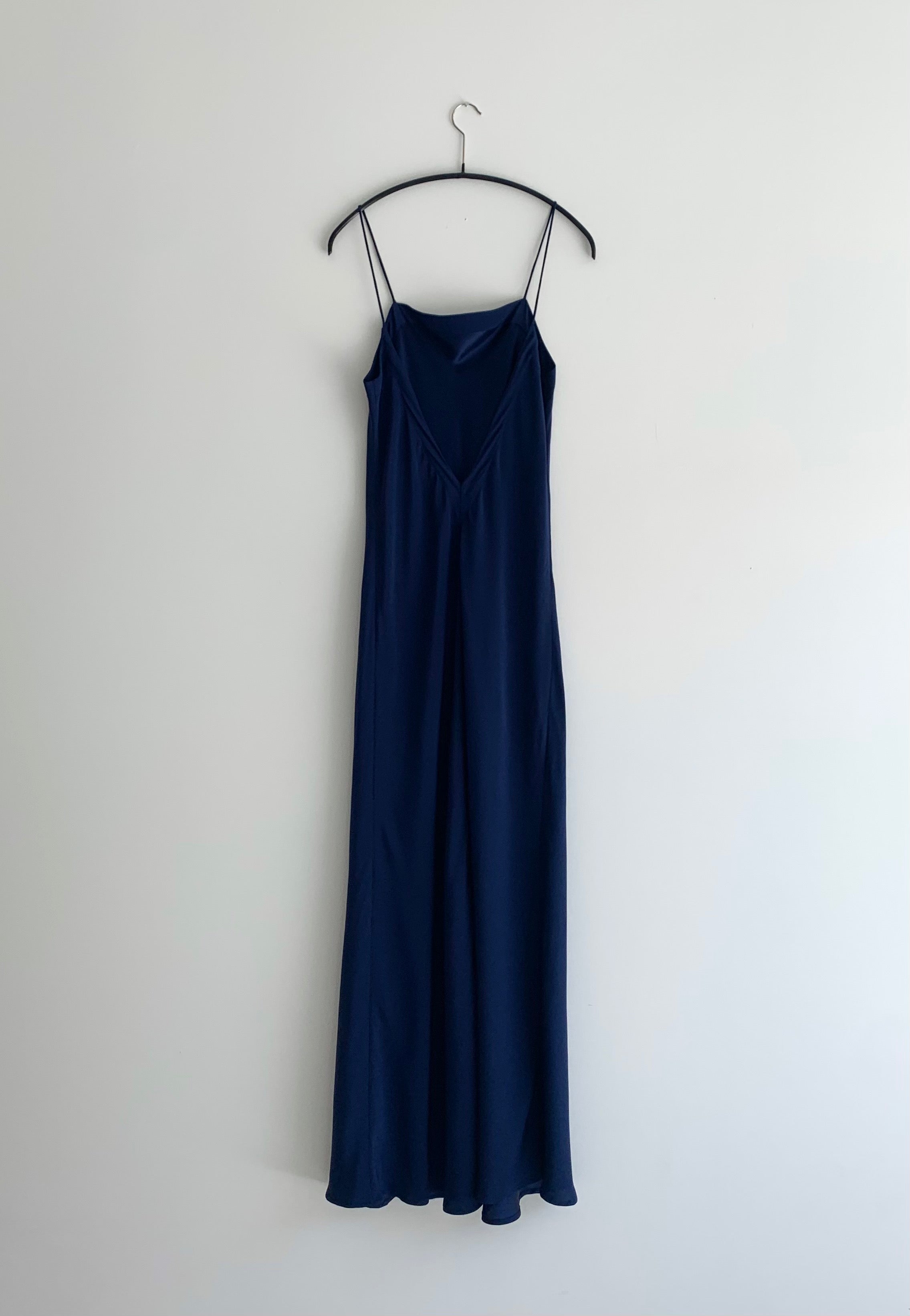Back view of the navy matte silk charmeuse Kamperett Long Slip showing the deep V back.