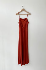 Back view of the rust matte silk charmeuse Kamperett Long Slip showing the deep V back.