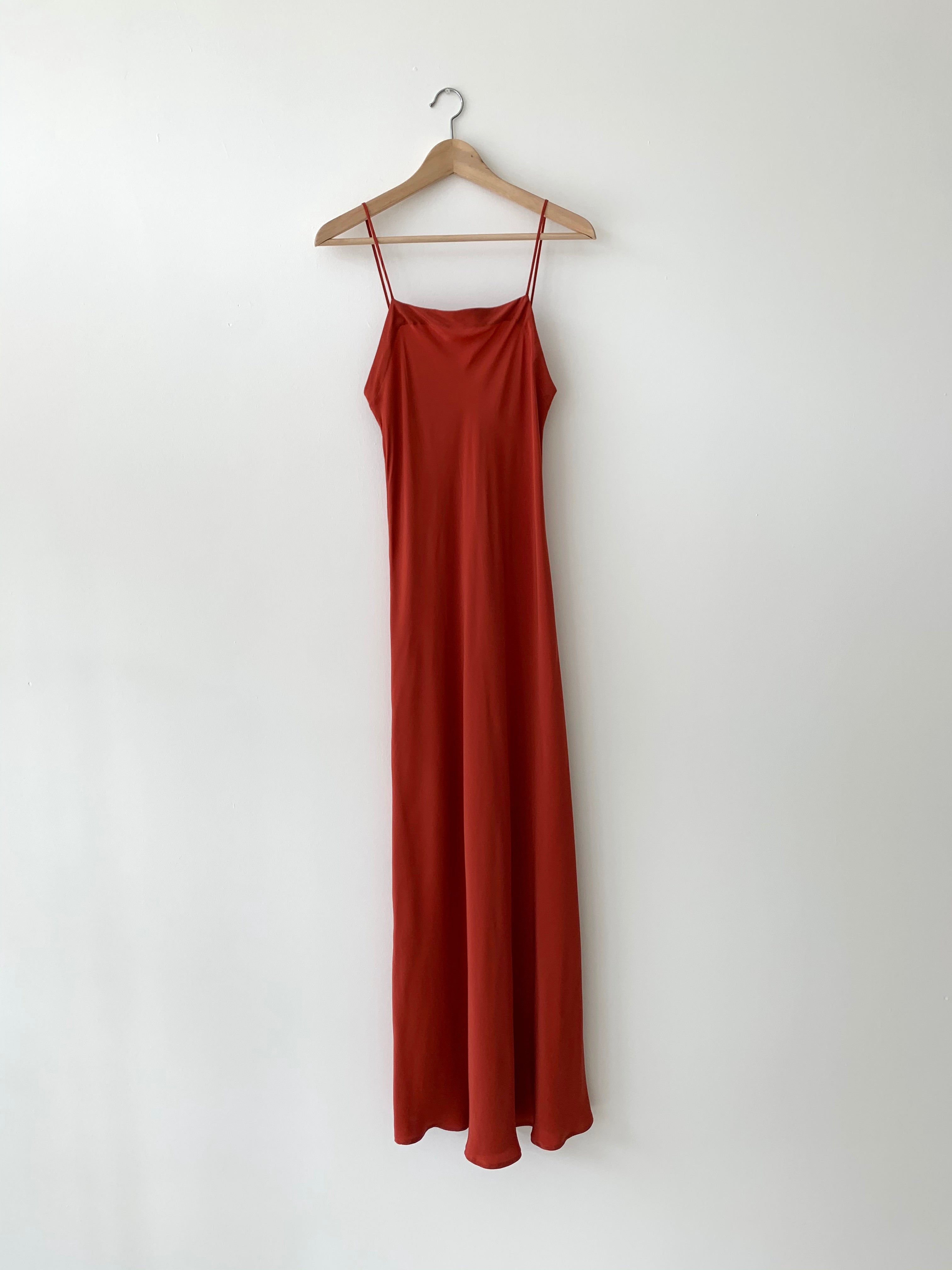 Front view of the rust matte silk charmeuse Kamperett Long Slip, a bias-cut maxi with straight neckline.