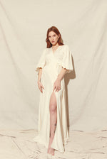 Back view of the alabaster four-ply silk crepe Kamperett Loretta Gown with wrap closure at the natural waist.