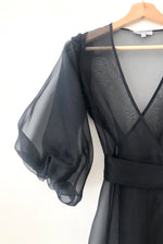 Side view of the black silk organza Kamperett Loretta Midi Dress with self-belt at the natural waist.
