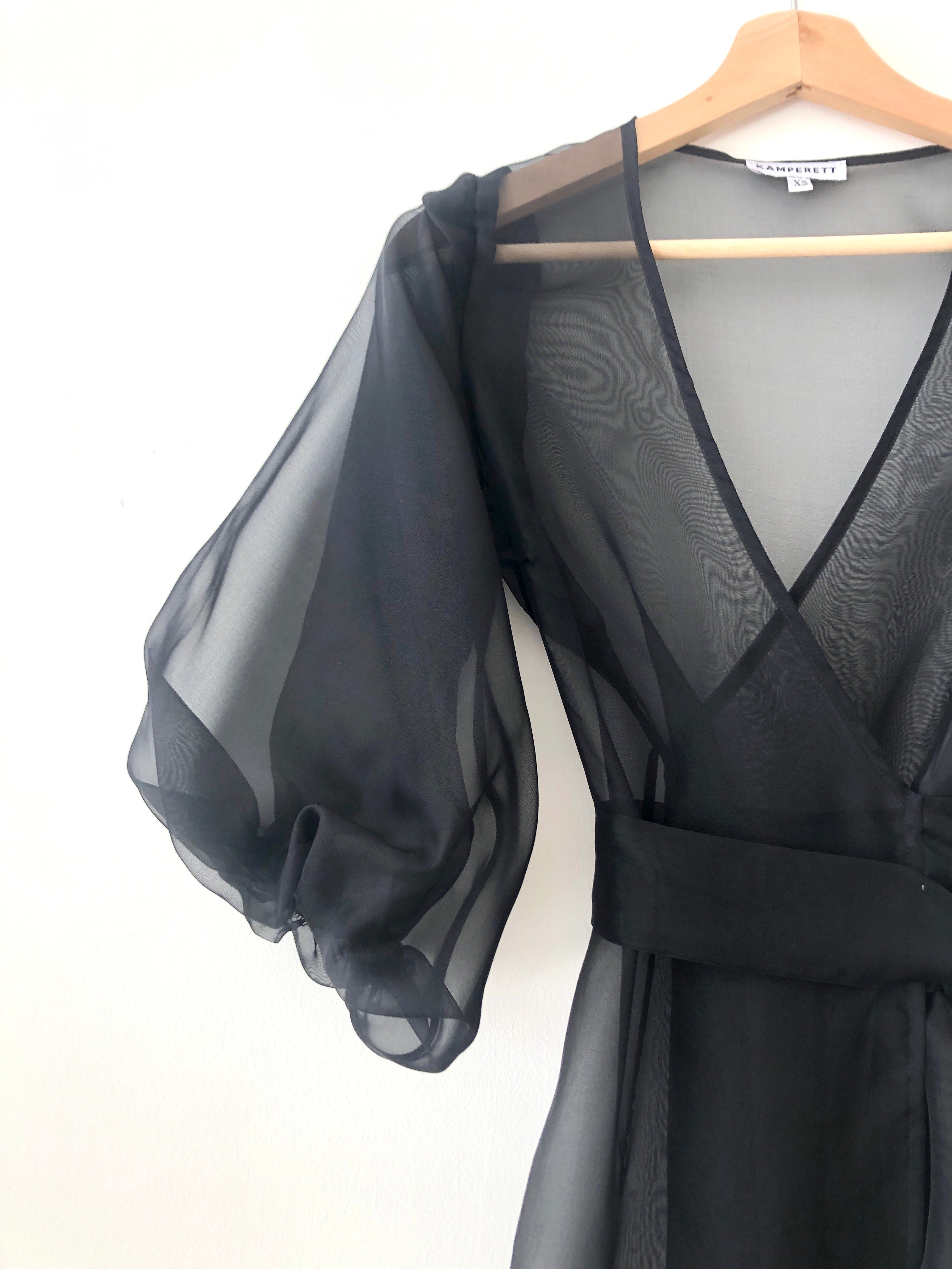 Side view of the black silk organza Kamperett Loretta Midi Dress with self-belt at the natural waist.