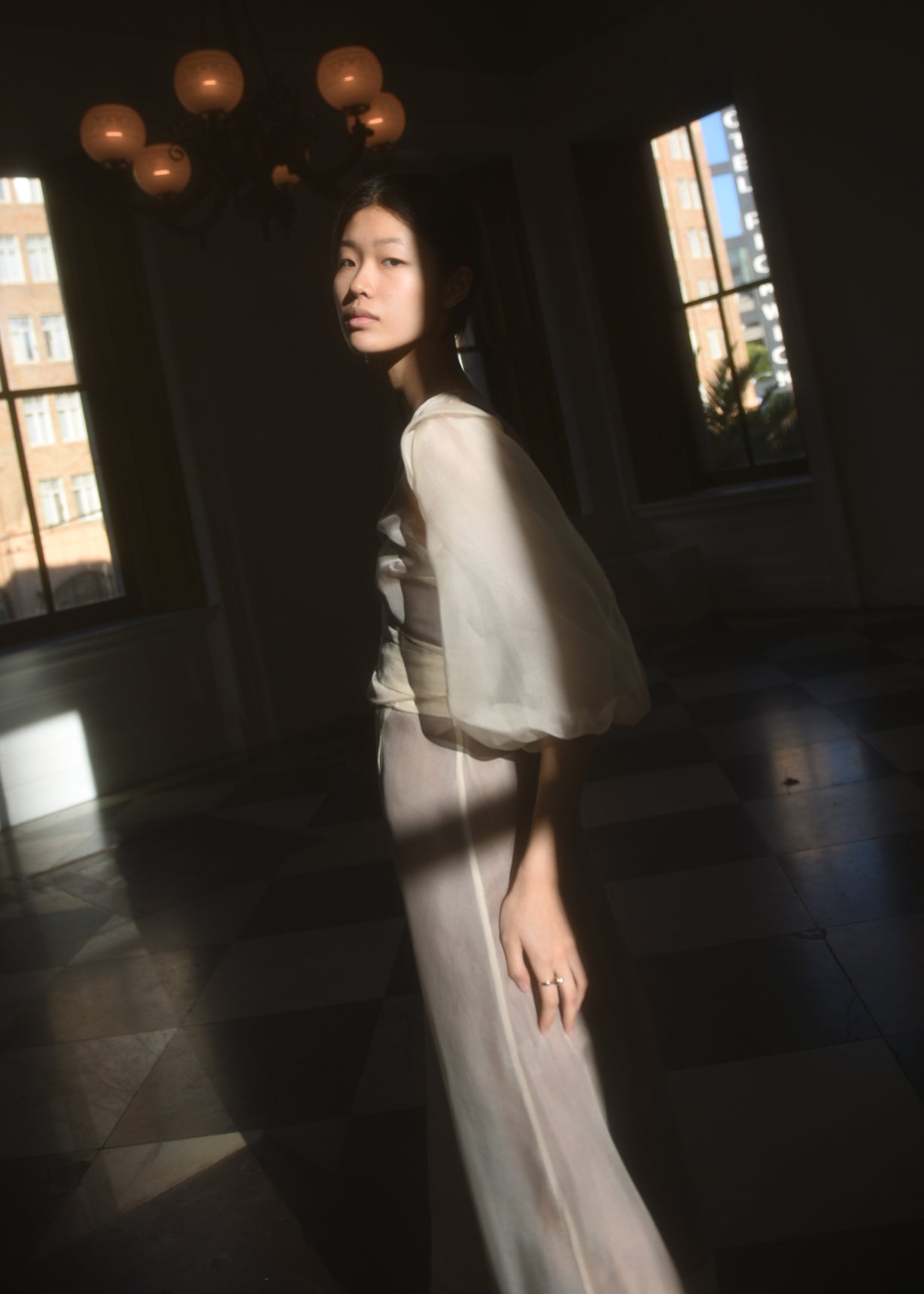 Side view of the ivory silk organza Kamperett Loretta Midi wedding dress with self-belt at the natural waist.